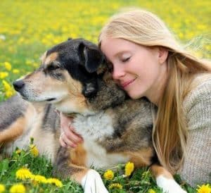 woman snuggling dog